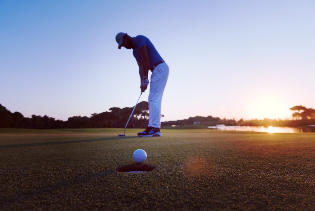 golfer hitting shot at golf course