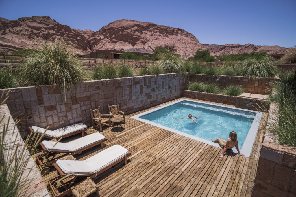 Couple at a private swimming pool at Hotel Alto Atacama Desert Lodge and Spa, San Pedro de Atacama,